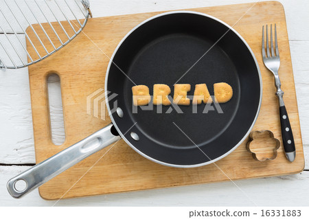 Alphabet crackers word BREAD putting in pan 16331883