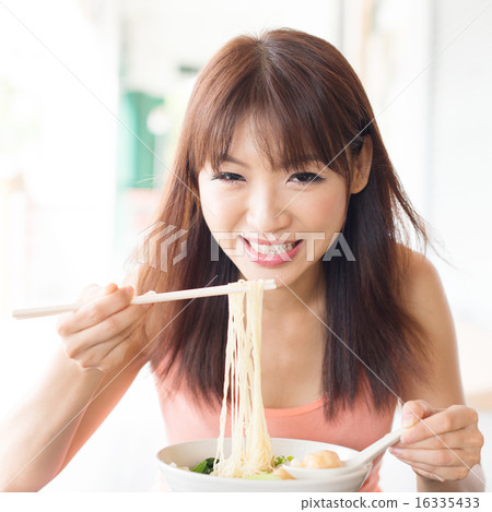 Asian girl eating ramen Asian girl eating ramen 16335433