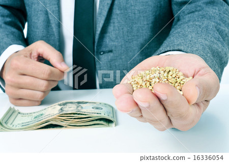 man with buckwheat seeds and dollar banknotes 16336054