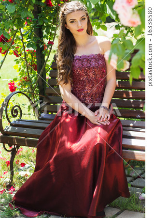 Beautiful woman is sitting on bench in park Beautiful woman is sitting on bench in park 16336580