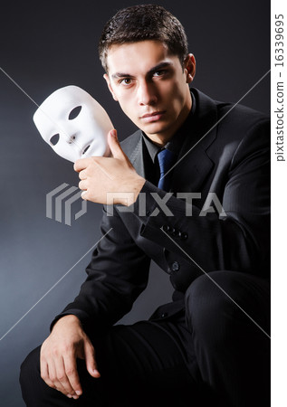 Man with mask in the dark 16339695