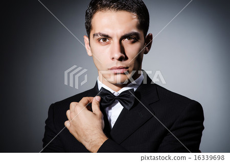 Portrait of man in dark studio 16339698
