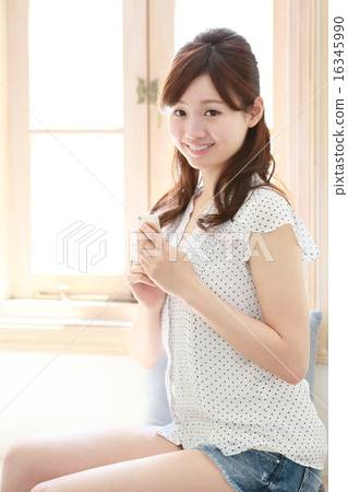 A woman relaxing at the window 16345990