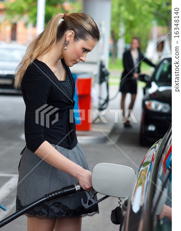 woman refuel her car woman refuel her car 16348140