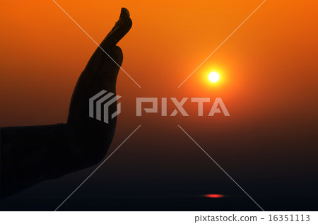 Silhouette of Hand and Sun in Twilight Light. Silhouette of Hand and Sun in Twilight Light. 16351113