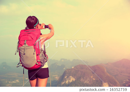 woman hiker taking photo mountian peak 16352739