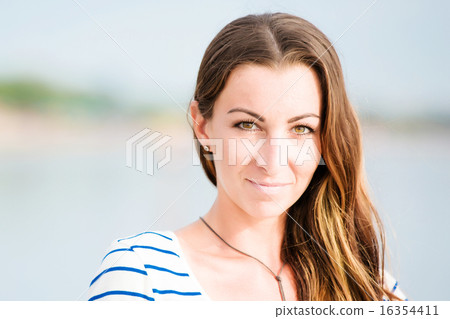 Beautifil young woman walking along the beach at sunset enjoing summer vacation Beautifil young woman walking along the beach at sunset enjoing summer vacation 16354411