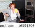 Happy adult woman on kitchen 16354806