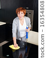 Woman cleaning kitchen 16354808