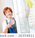 Woman cleaning window 16354811
