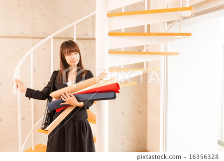 A woman carrying design materials A woman carrying design materials 16356328