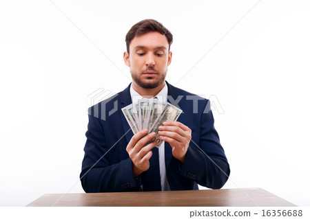 Handsome young man is calculating his savings 16356688