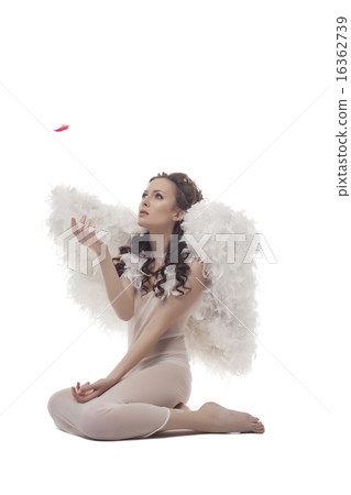 Shot of lovely guardian angel looks at red feather 16362739