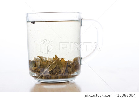 Green tea in glass cup with tea leafs Green tea in glass cup with tea leafs 16365094