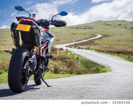 Large motorcycle looking at the winding mountain road ahead 16369198