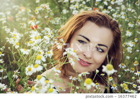Young caucasian brunette woman in daisy meadow Young caucasian brunette woman in daisy meadow 16377462