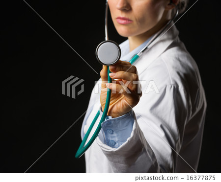 Closeup on medical doctor woman using stethoscope isolated on bl Closeup on medical doctor woman using stethoscope isolated on bl 16377875