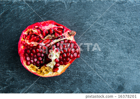 Closeup on pomegranate on stone substrate 16378201
