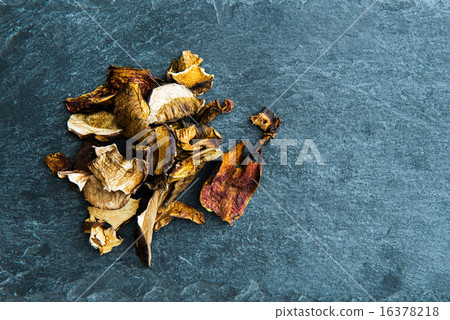 Closeup on dried mushrooms on stone substrate Closeup on dried mushrooms on stone substrate 16378218