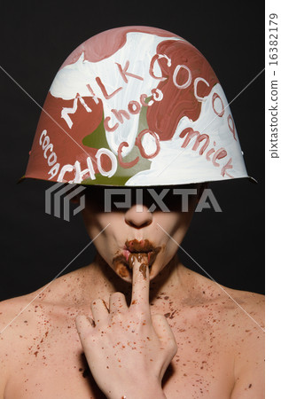 sexy woman in chocolate camouflage sucks finger 16382179