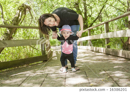 Mother and daughter in forest 16386201