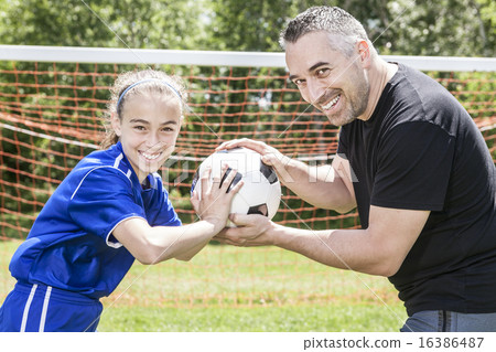 teenager girl with his father play soccer in a beautiful day teenager girl with his father play soccer in a beautiful day 16386487
