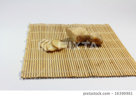 Ginger: Block and slice of ginger on bamboo sushi roll 16390981