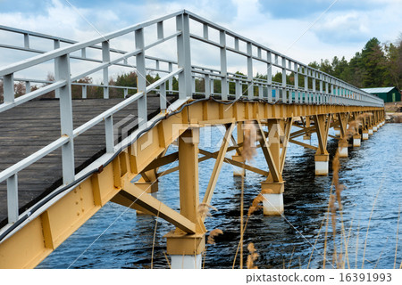 Steel bridge along river bank 16391993