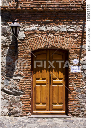 brown wood old door and a street lamp 16393563