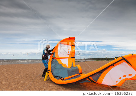 Kite surfer  is preparing his kite  16396282