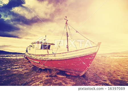 Vintage toned old ship on a beach at sunset. 16397089