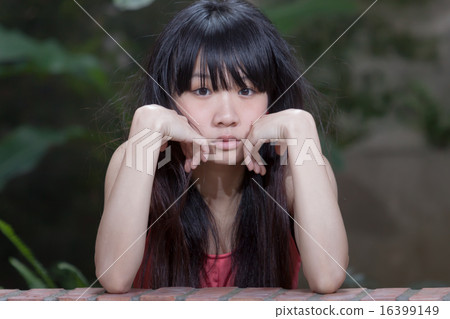 Asian girl by plants Asian girl by plants 16399149