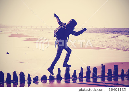 Vintage filtered silhouette of a woman running on wooden posts. Vintage filtered silhouette of a woman running on wooden posts. 16401185