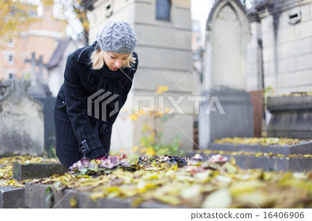 Solitary woman visiting relatives grave. Solitary woman visiting relatives grave. 16406906