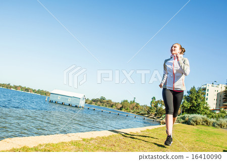 Young woman jogging near the river at sunny day Young woman jogging near the river at sunny day 16410090