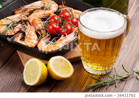 Grilled shrimps on frying pan and beer Grilled shrimps on frying pan and beer 16411702