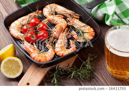 Grilled shrimps on frying pan and beer Grilled shrimps on frying pan and beer 16411703