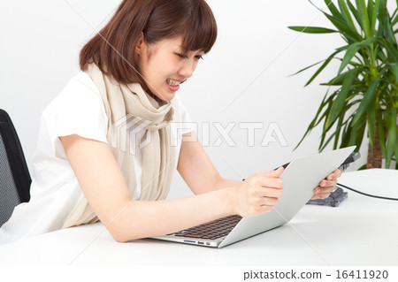 A woman raging anger on a personal computer 16411920
