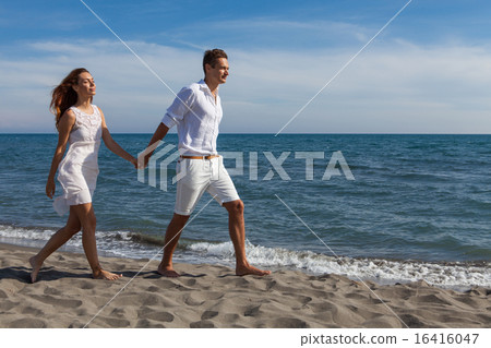 happy couple in love walking on the beach happy couple in love walking on the beach 16416047