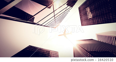 An airplane flying over buildings An airplane flying over buildings 16420510