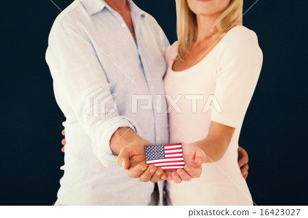 Composite image of happy couple holding their hands out Composite image of happy couple holding their hands out 16423027