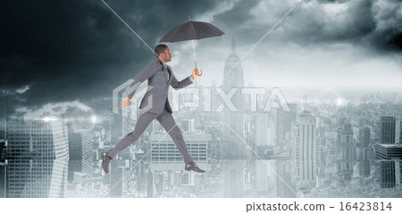 Composite image of businessman walking and holding umbrella Composite image of businessman walking and holding umbrella 16423814