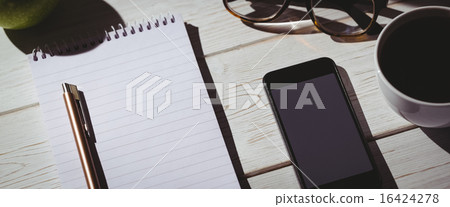 Overhead shot of notepad and smartphone Overhead shot of notepad and smartphone 16424278