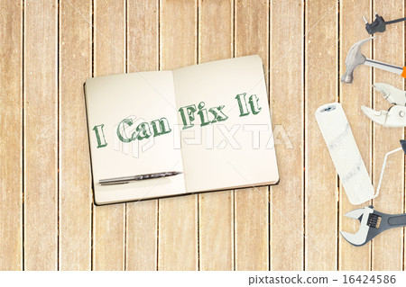 I can fix it against tools and notepad on wooden background 16424586