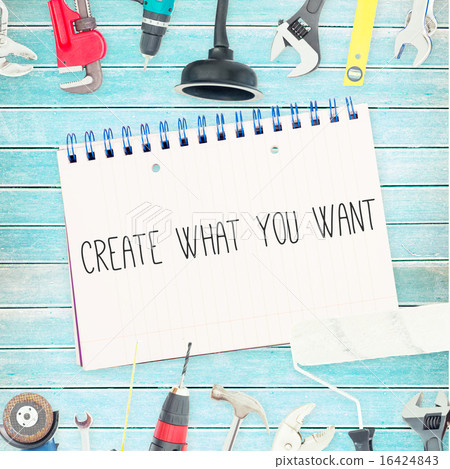 Create what you want against tools and notepad on wooden backgro 16424843