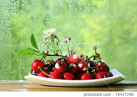 cherries in a bowl on the window 16427246