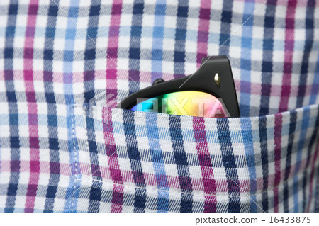 Sunglasses in a shirt pocket. 16433875