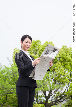 Business woman reading newspaper Business woman reading newspaper 16434782