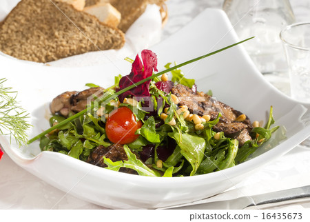 rabbit liver salad with arugula in a restaurant rabbit liver salad with arugula in a restaurant 16435673