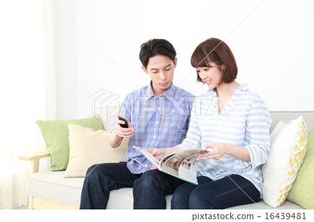 A couple ordering by looking at the catalog 16439481